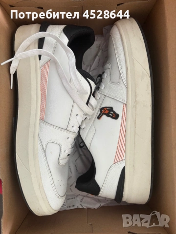 Продавам Cruyff Endorsed Tennis sneakers in a white colorway with orange and black accents