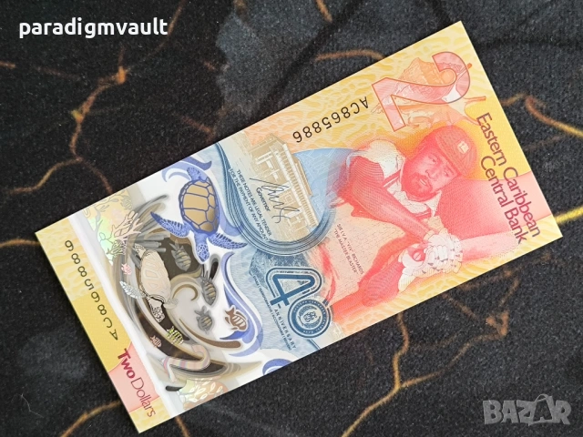 Банкнота - Източни Кариби - 2 долара (юбилейна) UNC | 2023г.