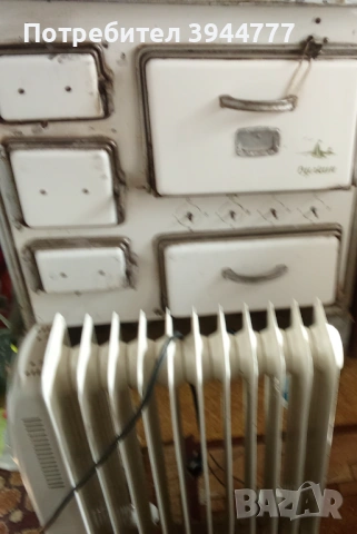 Стара печка Вулкан и радиатор Елдом