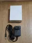 АС/DC адаптер модел GFDQ3L-0901000G. Той осигурява изходно напрежение 9.0V при ток 1.0A, снимка 1